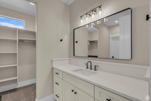 1816 S 920 W, Hurricane, UT 84737 - bathroom featuring a walk in closet, vanity, and baseboards
