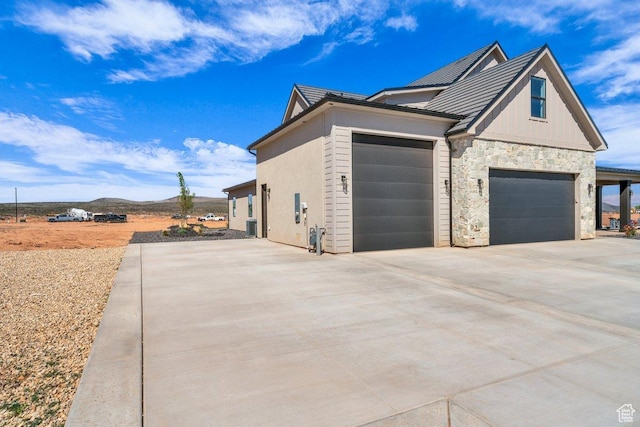 1816 S 920 W, Hurricane, UT 84737 - view of home's exterior featuring a mountain view, concrete driveway, a garage, and stone siding