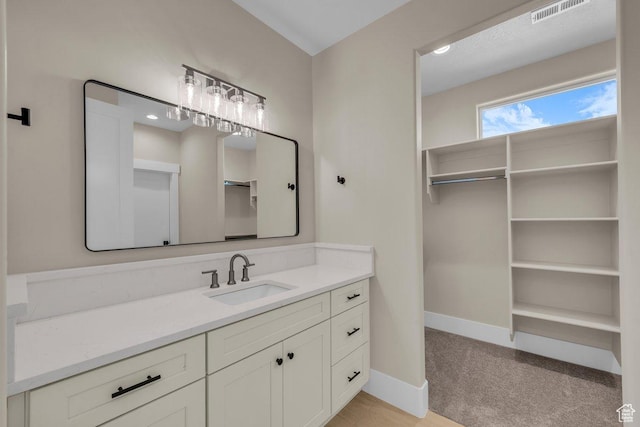 1816 S 920 W, Hurricane, UT 84737 - bathroom with a walk in closet, vanity, baseboards, and visible vents