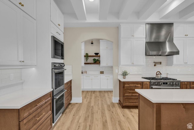 1816 S 920 W, Hurricane, UT 84737 - kitchen featuring tasteful backsplash, open shelves, light wood-style floors, wall chimney exhaust hood, and appliances with stainless steel finishes