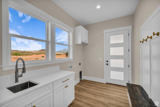 1816 S 920 W, Hurricane, UT 84737 - laundry room featuring a sink, cabinet space, light wood-style flooring, electric dryer hookup, and hookup for a washing machine