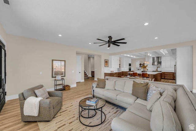 1816 S 920 W, Hurricane, UT 84737 - living room featuring light wood-type flooring, baseboards, recessed lighting, a ceiling fan, and stairs