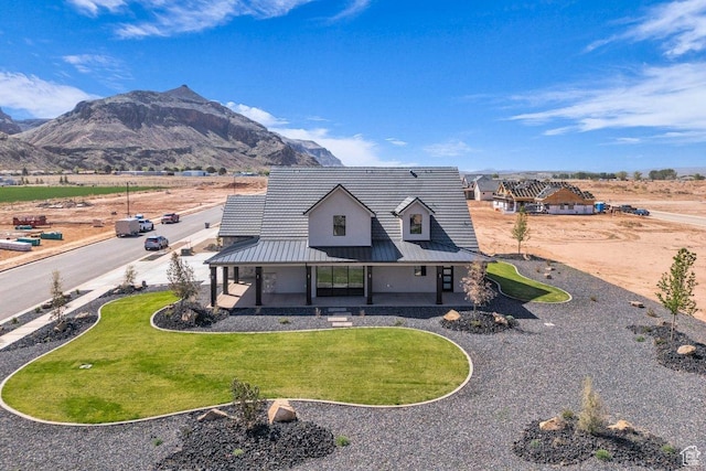 1816 S 920 W, Hurricane, UT 84737 - rear view of house featuring a standing seam roof, metal roof, a mountain view, and a lawn