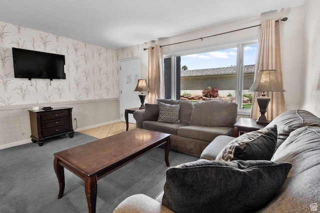 living room with baseboards, wainscoting, and wallpapered walls