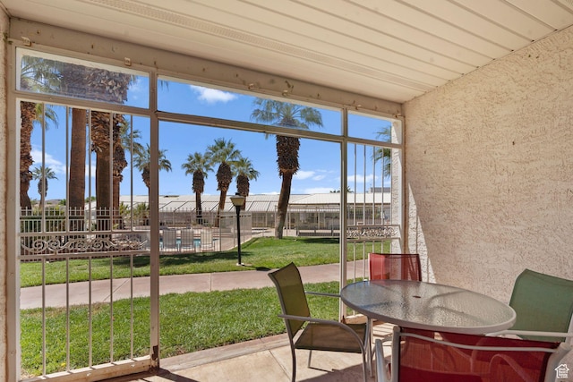 sunroom / solarium featuring outdoor dining space