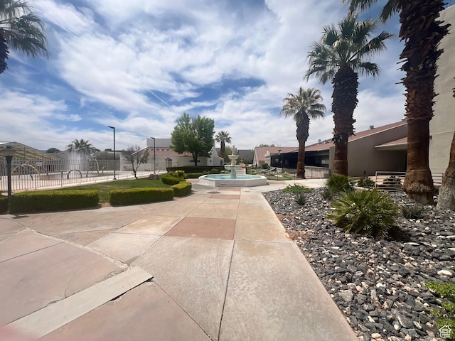 view of home's community featuring fence