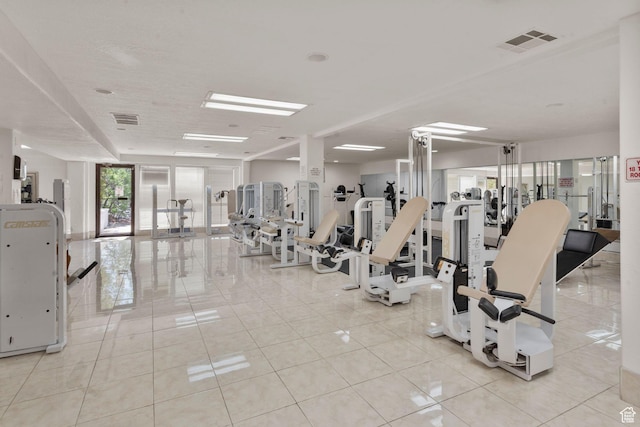 gym featuring visible vents and light tile patterned floors