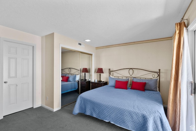bedroom featuring visible vents, a closet, baseboards, a textured ceiling, and carpet flooring