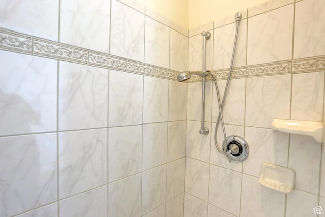 bathroom with a tile shower