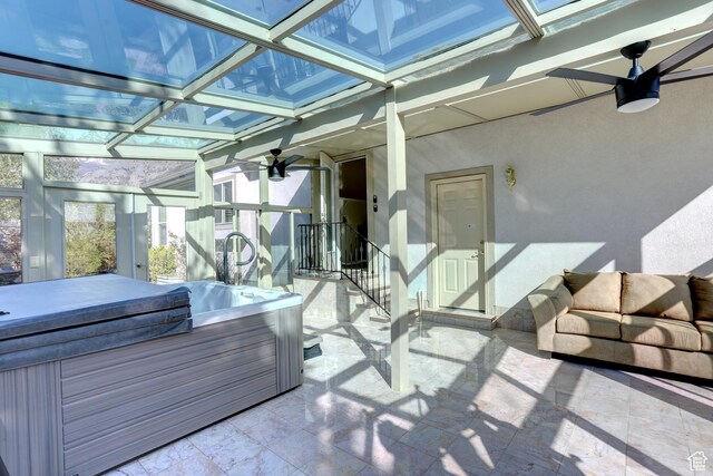 sunroom with a jacuzzi and coffered ceiling