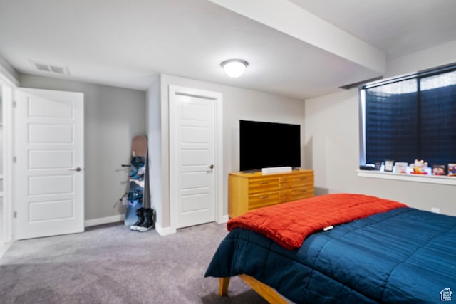 carpeted bedroom with visible vents and baseboards
