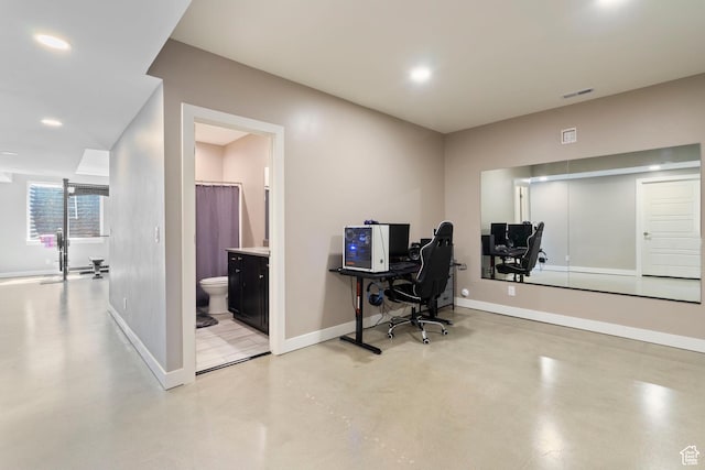 home office featuring finished concrete floors, baseboards, visible vents, and recessed lighting