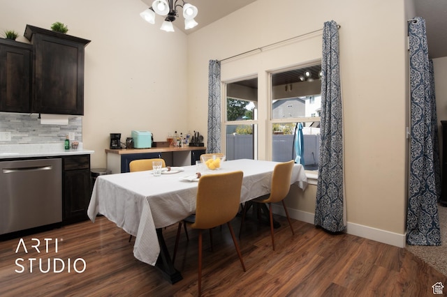 dining area with baseboards, an inviting chandelier, and dark wood finished floors