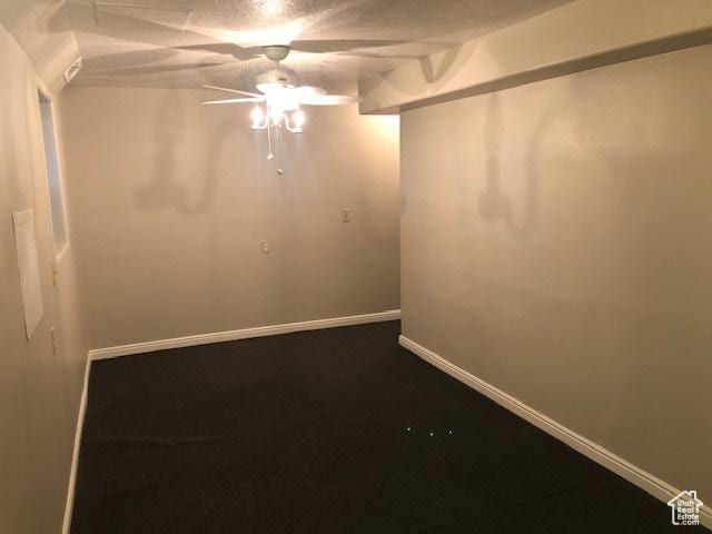 unfurnished room featuring ceiling fan and baseboards