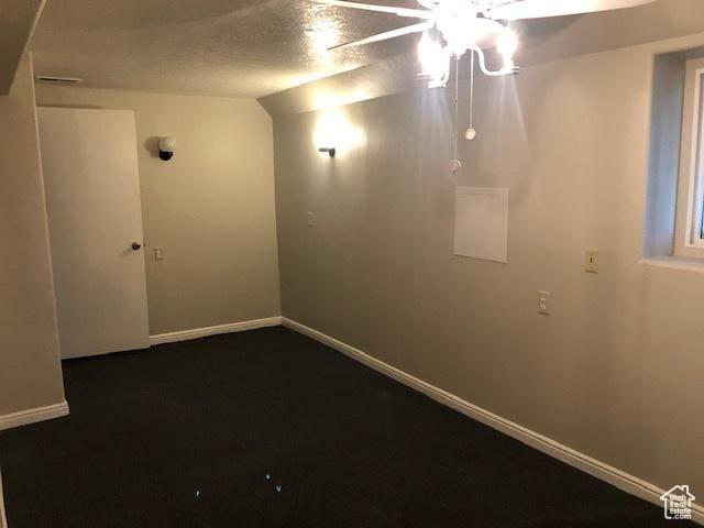 basement with baseboards and a ceiling fan