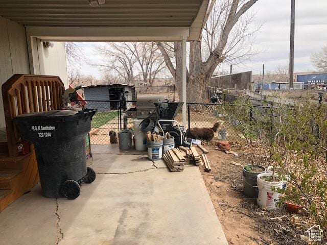 view of patio featuring an outdoor structure and fence