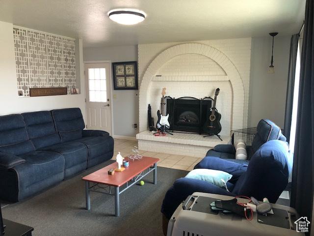 living area with a brick fireplace