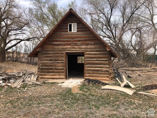 view of property exterior with an outbuilding and log siding