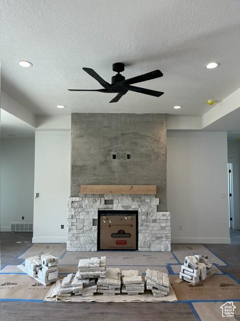 732 S 1140 E, Smithfield, UT 84335 - unfurnished living room with recessed lighting, a fireplace, a ceiling fan, visible vents, and a textured ceiling