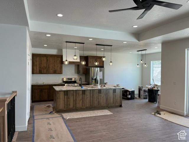 732 S 1140 E, Smithfield, UT 84335 - kitchen featuring stainless steel appliances, ceiling fan, wood finished floors, baseboards, and an island with sink