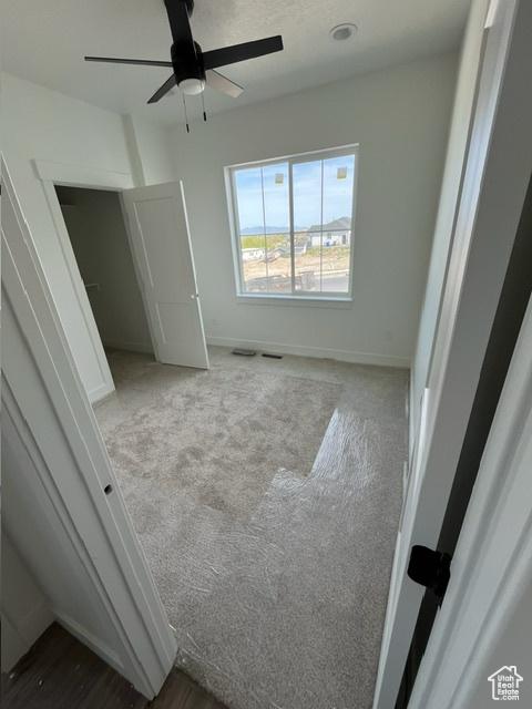 732 S 1140 E, Smithfield, UT 84335 - unfurnished bedroom with carpet, a ceiling fan, and baseboards