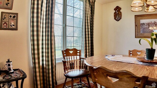 3193 S Southfield Rd W, Daniel, UT 84032 - dining room featuring wood finished floors, an inviting chandelier, and plenty of natural light