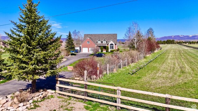 3193 S Southfield Rd W, Daniel, UT 84032 - exterior space with an attached garage, driveway, fence, and a front lawn