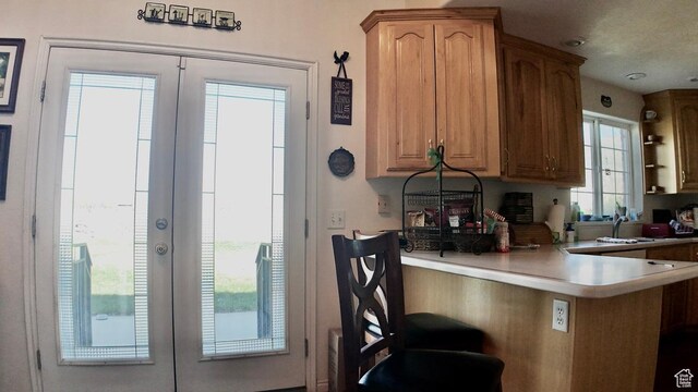 3193 S Southfield Rd W, Daniel, UT 84032 - kitchen with a peninsula, french doors, light countertops, and a kitchen breakfast bar
