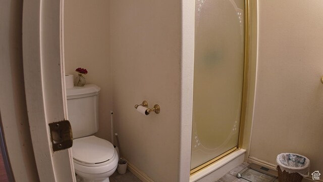 3193 S Southfield Rd W, Daniel, UT 84032 - full bathroom with tile patterned floors, toilet, a stall shower, and baseboards