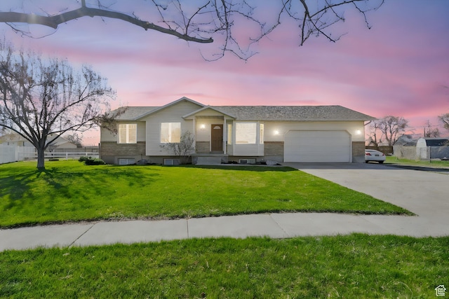 ranch-style house featuring a front yard, a garage, and concrete driveway