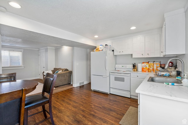 1055 W 325 N, Hyrum, UT 84319 - kitchen featuring baseboards, white appliances, white cabinetry, dark wood finished floors, and a sink