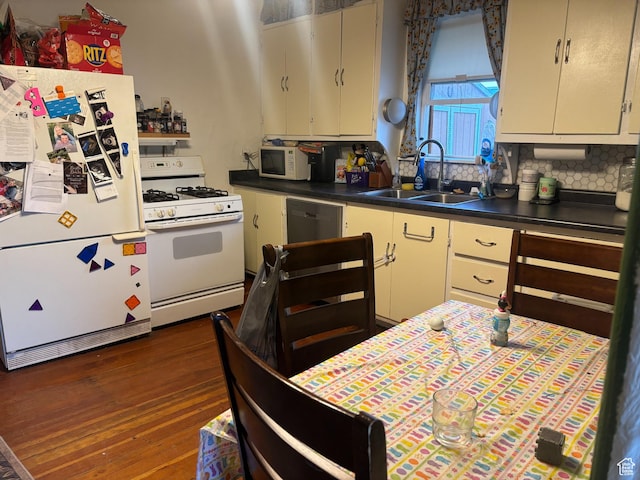 80 N 100 W, Redmond, UT 84652 - kitchen with white appliances, dark wood-style floors, backsplash, dark countertops, and a sink