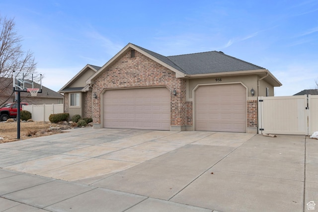956 S 1525 W, Syracuse, UT 84075 - ranch-style house featuring a garage, brick siding, driveway, and fence