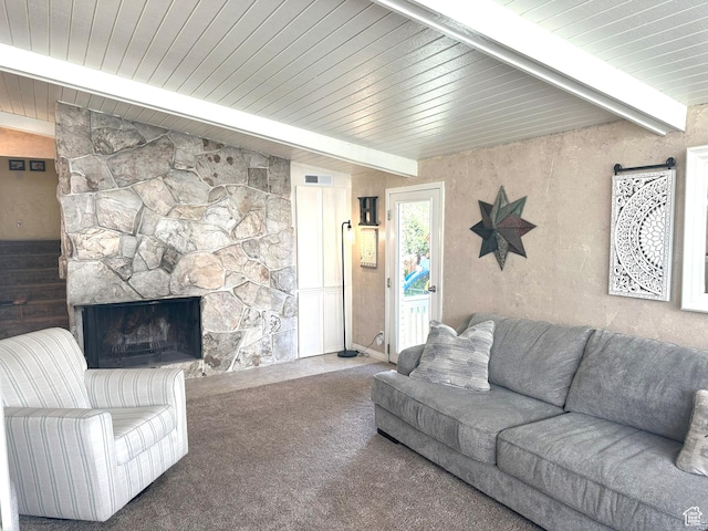 carpeted living area featuring wood ceiling, beamed ceiling, a fireplace, and visible vents