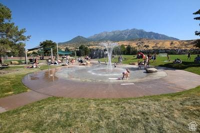 view of property's community featuring a yard and a mountain view