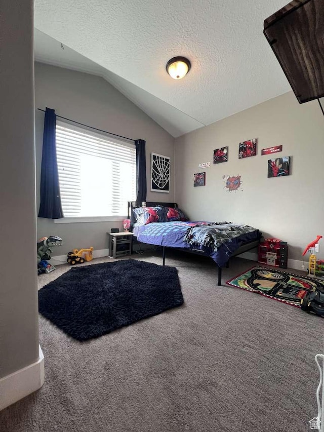 carpeted bedroom featuring lofted ceiling and a textured ceiling