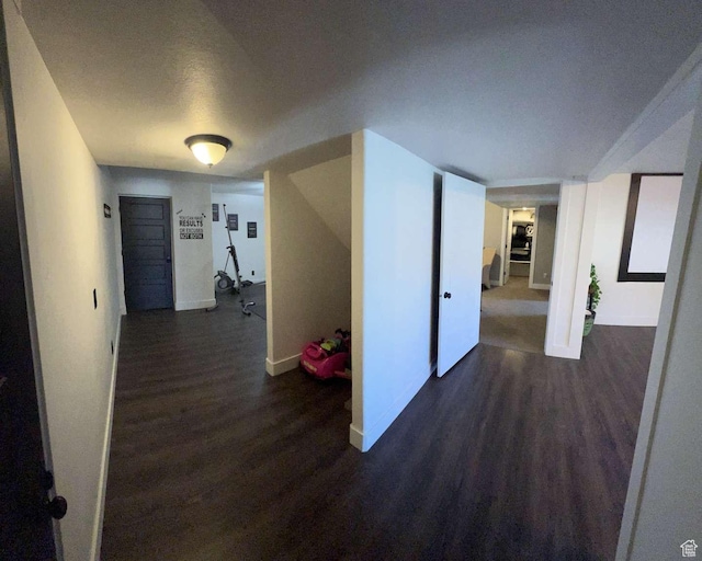 hall with wood finished floors and baseboards