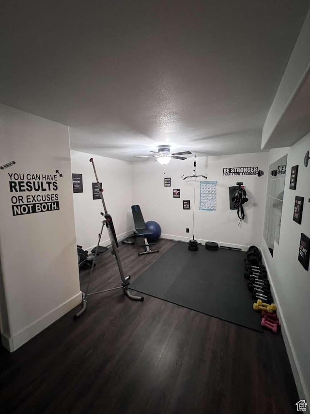 workout area featuring wood finished floors, baseboards, and ceiling fan