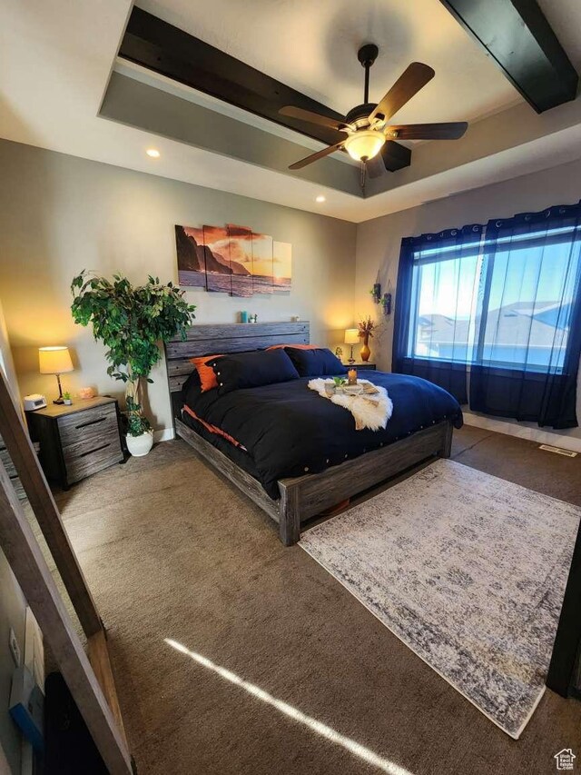 carpeted bedroom with a ceiling fan, recessed lighting, and a raised ceiling