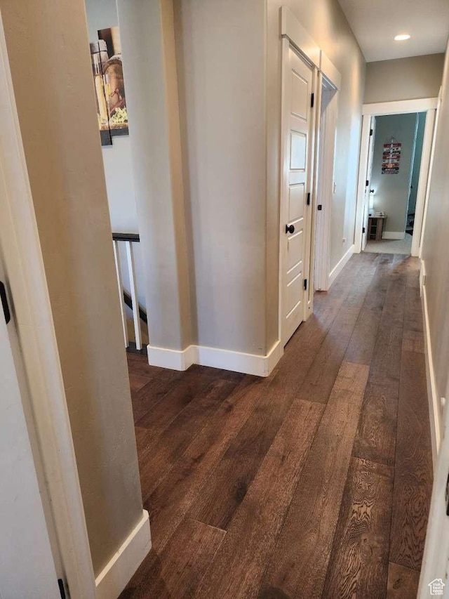 hallway with baseboards, dark wood-style floors, and recessed lighting