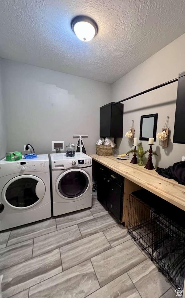 laundry room featuring separate washer and dryer, a textured ceiling, and laundry area