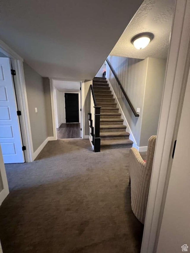 stairs with baseboards and carpet flooring