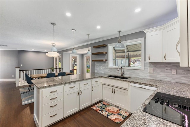 kitchen with tasteful backsplash, white dishwasher, a sink, a peninsula, and crown molding