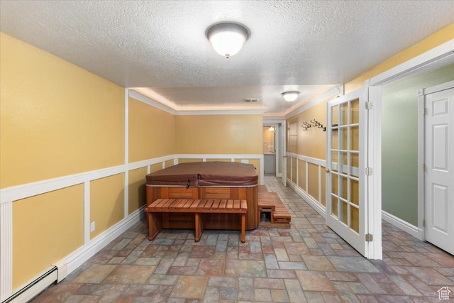 dining area with crown molding, a textured ceiling, baseboard heating, french doors, and baseboards