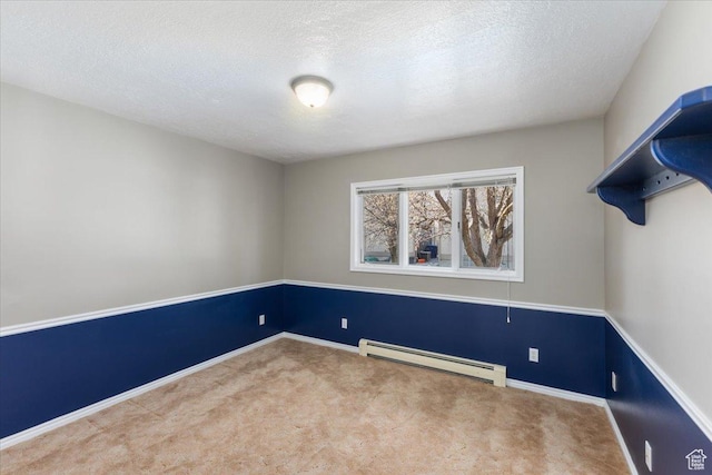 unfurnished room with a baseboard radiator, carpet flooring, baseboards, and a textured ceiling