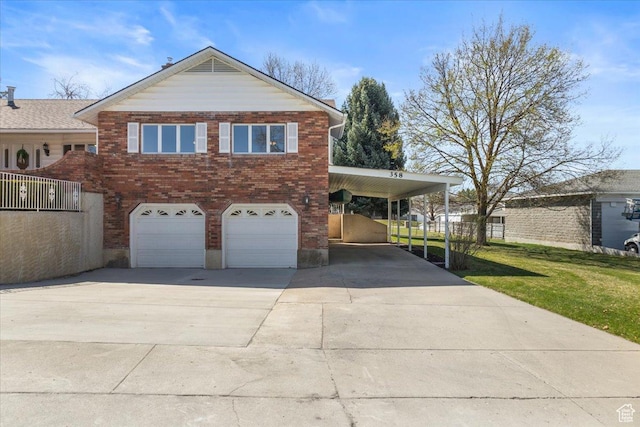 view of front of house with a front yard, a carport, an attached garage, concrete driveway, and brick siding