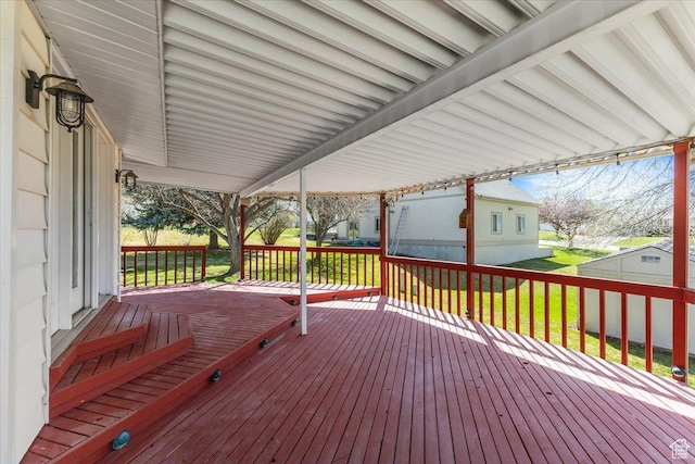 wooden terrace with a lawn