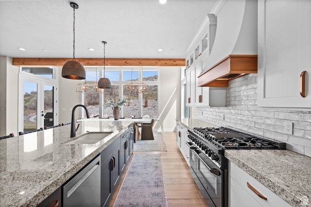 kitchen with recessed lighting, custom range hood, a sink, dishwasher, and double oven range