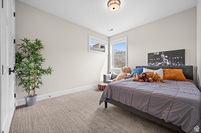 bedroom with carpet floors, baseboards, and visible vents