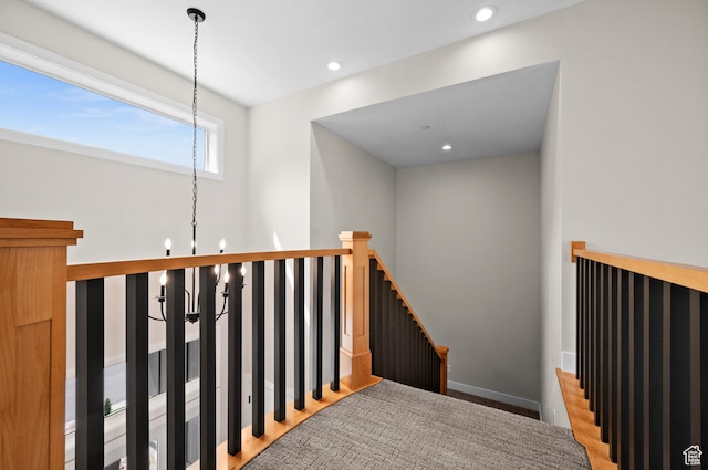 stairs with recessed lighting and a chandelier